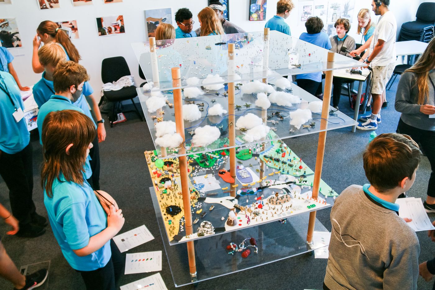 Children around the four-level World Peace Game board